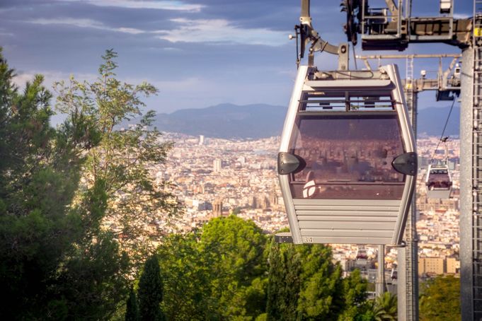 Cable car approaching Montjuïc with Barcelona city skyline in view