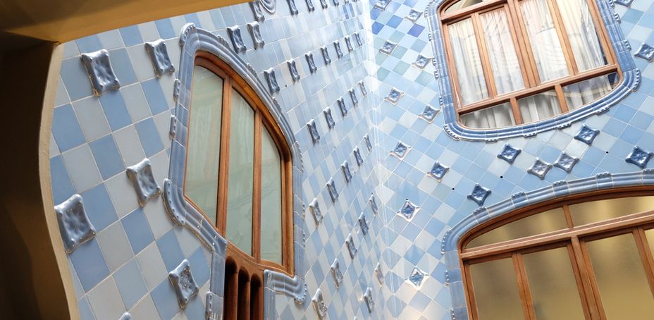 Casa Batlló by Antoni Gaudí, renowned for its blue tile facade and architectural innovation.