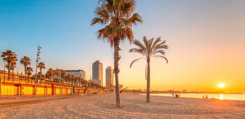 Barceloneta Beach in Barcelona with colorful sky at sunrise