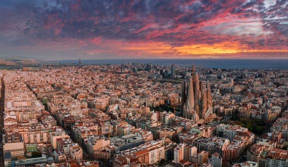 Barcelona, Spain. May 01, 2023. Aerial view of Barcelona City Skyline and Sagrada Familia Cathedral at sunset. Eixample residential famous urban grid.