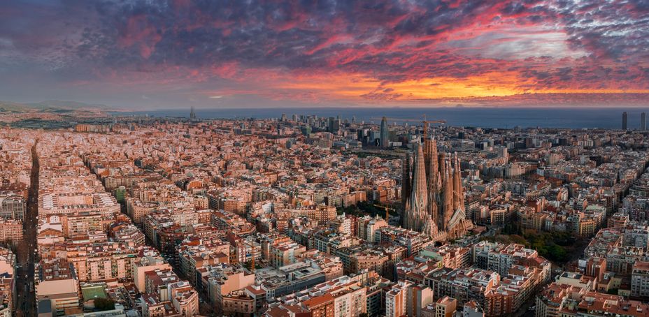 Barcelona, Spain. May 01, 2023. Aerial view of Barcelona City Skyline and Sagrada Familia Cathedral at sunset. Eixample residential famous urban grid.