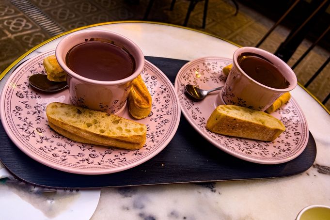 Two cups of thick chocolate with breadsticks, a typical Spanish breakfast