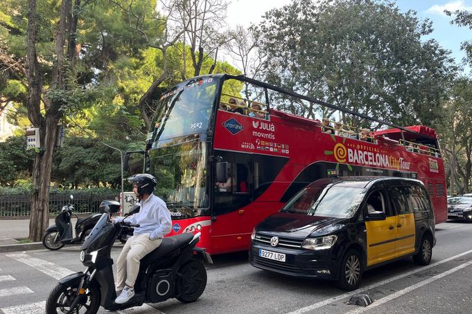 A red bus among Barcelona traffic