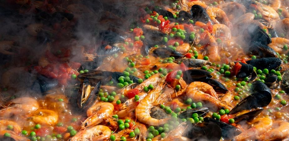 Palo Market. Fresh prepared colorful paella with rice and sea food in big pan, ready to eat